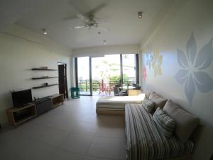 a living room with a couch and a tv at Costa Pacifica Baler in Baler