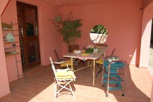 a dining room with a table and chairs on a patio at Apt. Marilena by SolturElba in Capoliveri