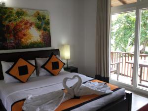Postel nebo postele na pokoji v ubytování Joe's Resort Unawatuna + 30 fotografií