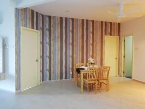 a dining room with a table and chairs at SinggahSini Suite @ Atlantis Residences in Melaka