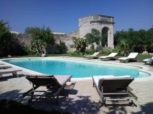 a swimming pool with two lounge chairs at Palazzo Vecchio in Marittima