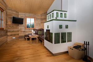 a living room with a fireplace in a log cabin at Family Retreat Maria Alm in Maria Alm am Steinernen Meer