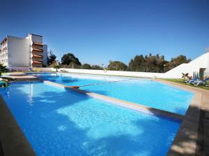 a large swimming pool with blue water at Ocean View Apartments in Portimão