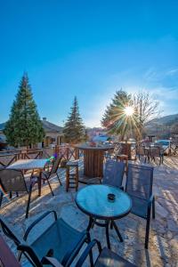 a group of tables and chairs on a patio at Matzato in Monodendri