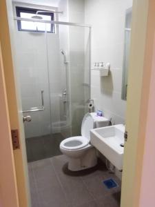 a bathroom with a shower and a toilet and a sink at SinggahSini Suite @ Atlantis Residences in Melaka