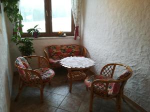 a room with a table and chairs and a couch at Sinsamreith, Familie Ensmann in Göstling an der Ybbs