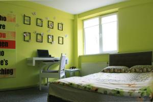 ヤシにあるApartament Copouの緑の壁のベッドルーム(ベッド1台、デスク付)