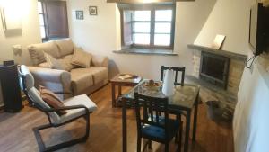 a living room with a couch and a table at Casa Carballeira in Villarfernando