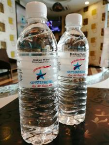 two bottles of water sitting on top of a table at Sky Star Hotel KLIA/KLIA2 in Sepang