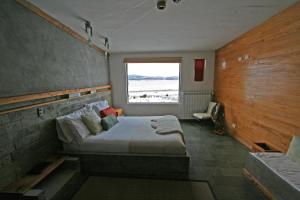 Ένα ή περισσότερα κρεβάτια σε δωμάτιο στο Hotel Altiplanico Puerto Natales