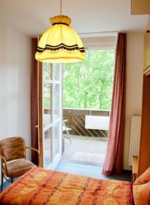 a bedroom with a bed and a large window at Nationalparkresidenz in Lindberg