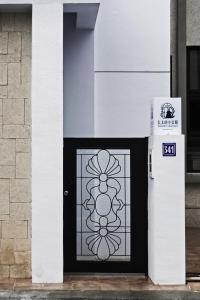 a black and white door with a flower on it at 太太的小公館 民宿 僅限 13 歲以上旅客入住 in Taitung City