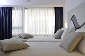 Letto o letti in una camera di Hotel Poseidon