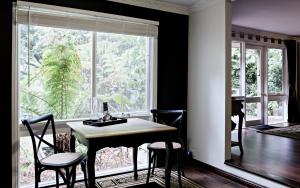 a dining room with a table and chairs and a window at Belle Le Vie in Sassafras
