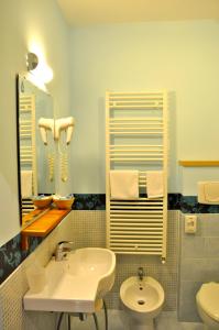 a bathroom with a sink and a toilet and a mirror at Letto & Riletto in Montecassiano