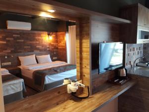 A bed or beds in a room at THE SARIGERME INN