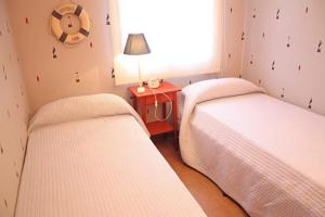 A bed or beds in a room at Beautiful seafront house Még 20 kép