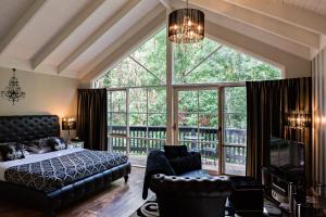 a bedroom with a bed and a large window at Belle Le Vie in Sassafras