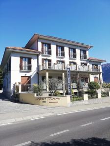 un bâtiment blanc sur le côté d'une rue dans l'établissement Hotel Fioroni, à Bellagio