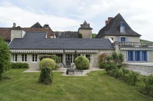 an old house with a garden in front of it at Le Prieuré L´Atelier in Lanzac