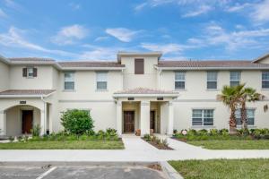 a large white house with a palm tree at Imagine You and Your Family Renting this 5 Star Home on Champions Gate Resort, Orlando Townhome 2539 in Davenport