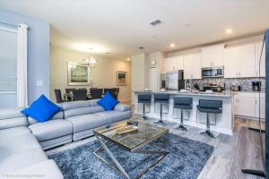 a living room with a couch and a table at Imagine You and Your Family Renting this 5 Star Home on Champions Gate Resort, Orlando Townhome 2539 in Davenport