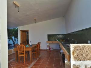 a kitchen with a wooden table and chairs and a counter at Apartament in arico in Arico el Nuevo