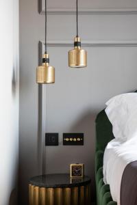 a bedroom with two pendant lights and a bed at Chapter Roma in Rome