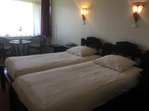 Een bed of bedden in een kamer bij Hotel Den Helder