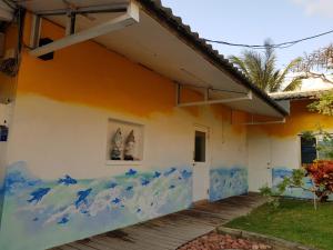 a house with a painting on the side of it at Kenting Sun & Sea B&B in Nanwan
