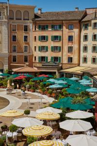 a large group of umbrellas and tables and buildings at 4-Sterne Superior Erlebnishotel Colosseo, Europa-Park Erlebnis-Resort in Rust