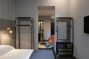 a bedroom with two bunk beds and a mirror at Chapter Roma in Rome
