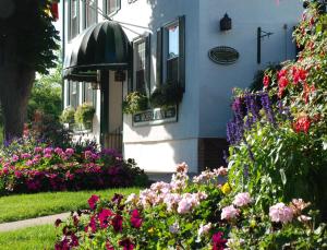 a house with flowers in front of it at Moffat Inn in Niagara-on-the-Lake