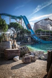 a water park with a roller coaster in the background at 4-Sterne Burghotel Castillo Alcazar, Europa-Park Erlebnis-Resort in Rust
