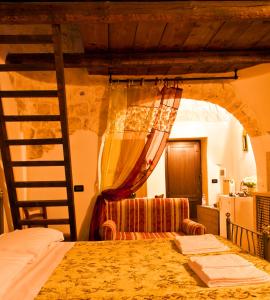 a bedroom with a bunk bed and a ladder at Giardino Dei Trulli in Alberobello