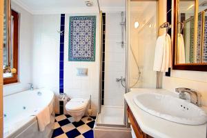 a bathroom with a tub and a sink and a toilet at Hotel Sumengen in Istanbul