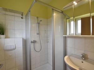 a bathroom with a shower and a tub and a sink at Gruppenurlaub im Ferienhaus in Zierow für 12 Gäste in Zierow +21 photos