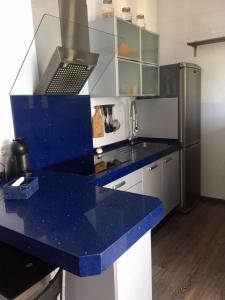 a kitchen with a blue counter top and a refrigerator at Apartamento/Loft en Zona Céntrica III in Jerez de la Frontera