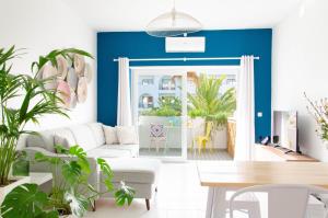 a living room with a white couch and a blue wall at Algarve Beaches Apartment by Portugal Collection in Porches