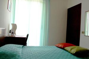 Postel nebo postele na pokoji v ubytování Hotel Villa Truentum