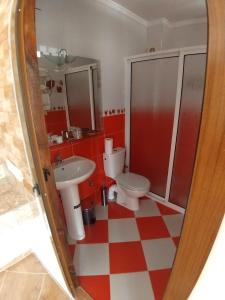 a bathroom with two toilets and a red and white checkered floor at TANJITAN HOSPITALITE in Tangier