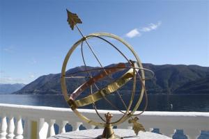 a metal orb on top of a table on a balcony at Holiday Hotel YACHTSPORT RESORT in Brissago