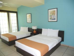 Tempat tidur dalam kamar di Parador Villas Del Mar Hau
