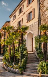 um edifício com palmeiras em frente em Romantik Hotel Castello Seeschloss em Ascona
