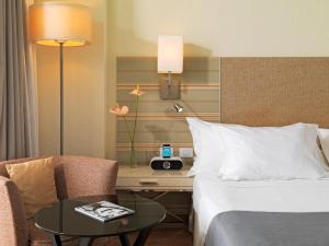a hotel room with a bed and a desk and a table at H10 Gran Tinerfe - Adults Only in Adeje