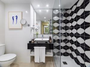 a bathroom with a sink and a toilet at H10 Gran Tinerfe - Adults Only in Adeje