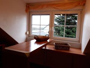 a kitchen with a table and a window with baskets on it at Ferienwohnung Farrenkopf in Hambrunn +12 photos