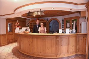 a man and woman standing at a bar in a restaurant at Hotel & Gasthof Richard Held in Regensburg +37 photos