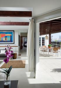 a living room with a glass door leading to a dining room at Coral Villas in Puerto del Carmen