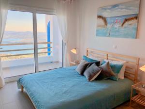 a bedroom with a bed and a large window at House Teigan of Villa Intaba Breath Taking Sea Views Corfiot Riviera Corfu Island Greece with Pool close to Ipsos Beach in Corfu Town